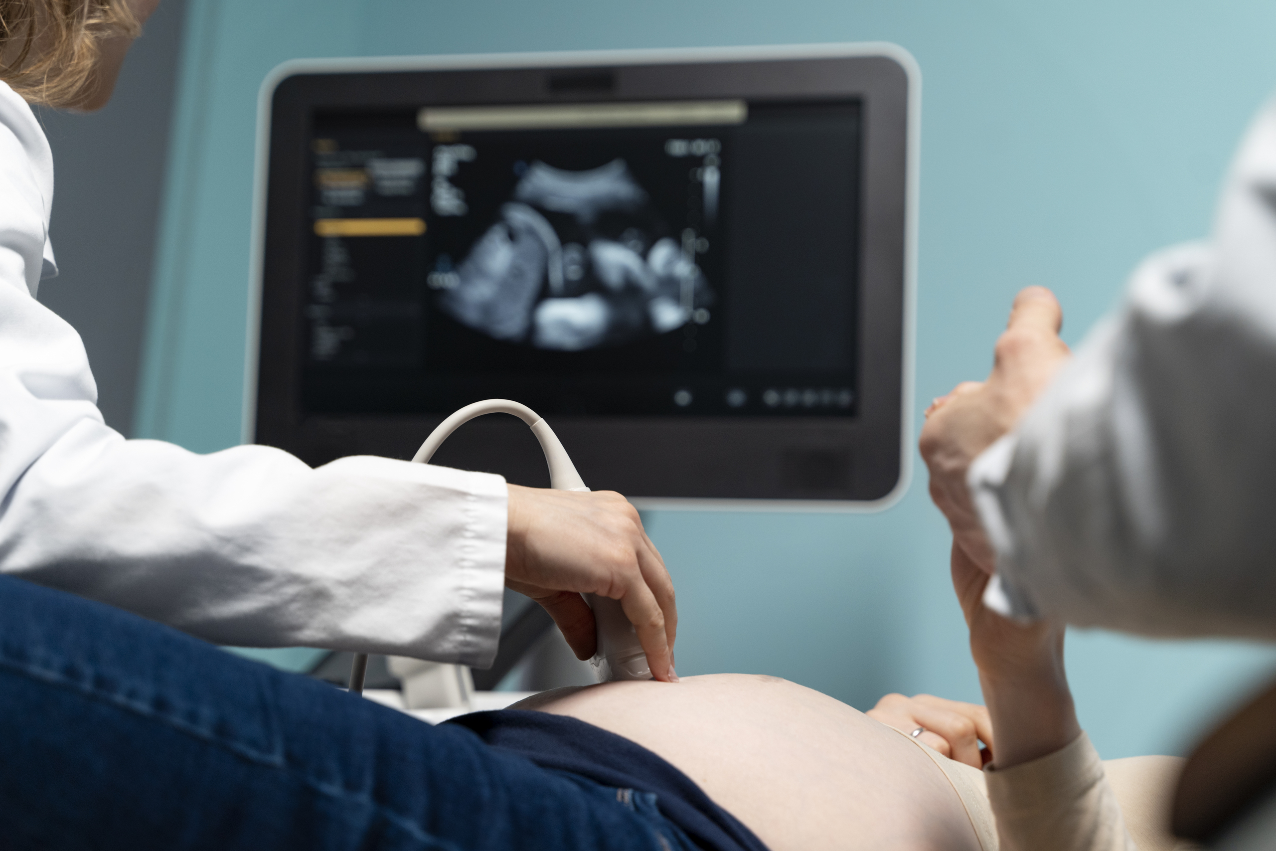 A couple getting their pregnancy ultrasound done.